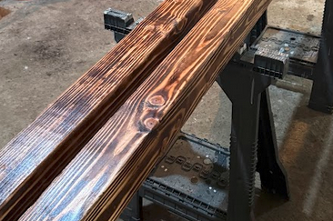 4×4 leg on sawhorses during sanding and oiling process