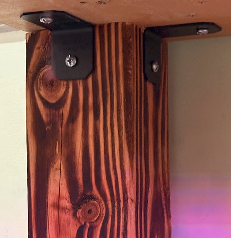 Installed yakisugi leg attached to underside of tabletop with Simpson L-bracket